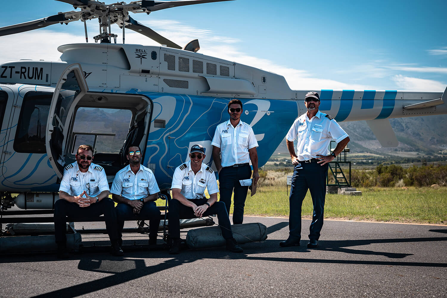 Nac pilots in front of helicopter